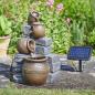Preview: Solar-Wasserbrunnen mit Solarmodul im Garten aufgebaut